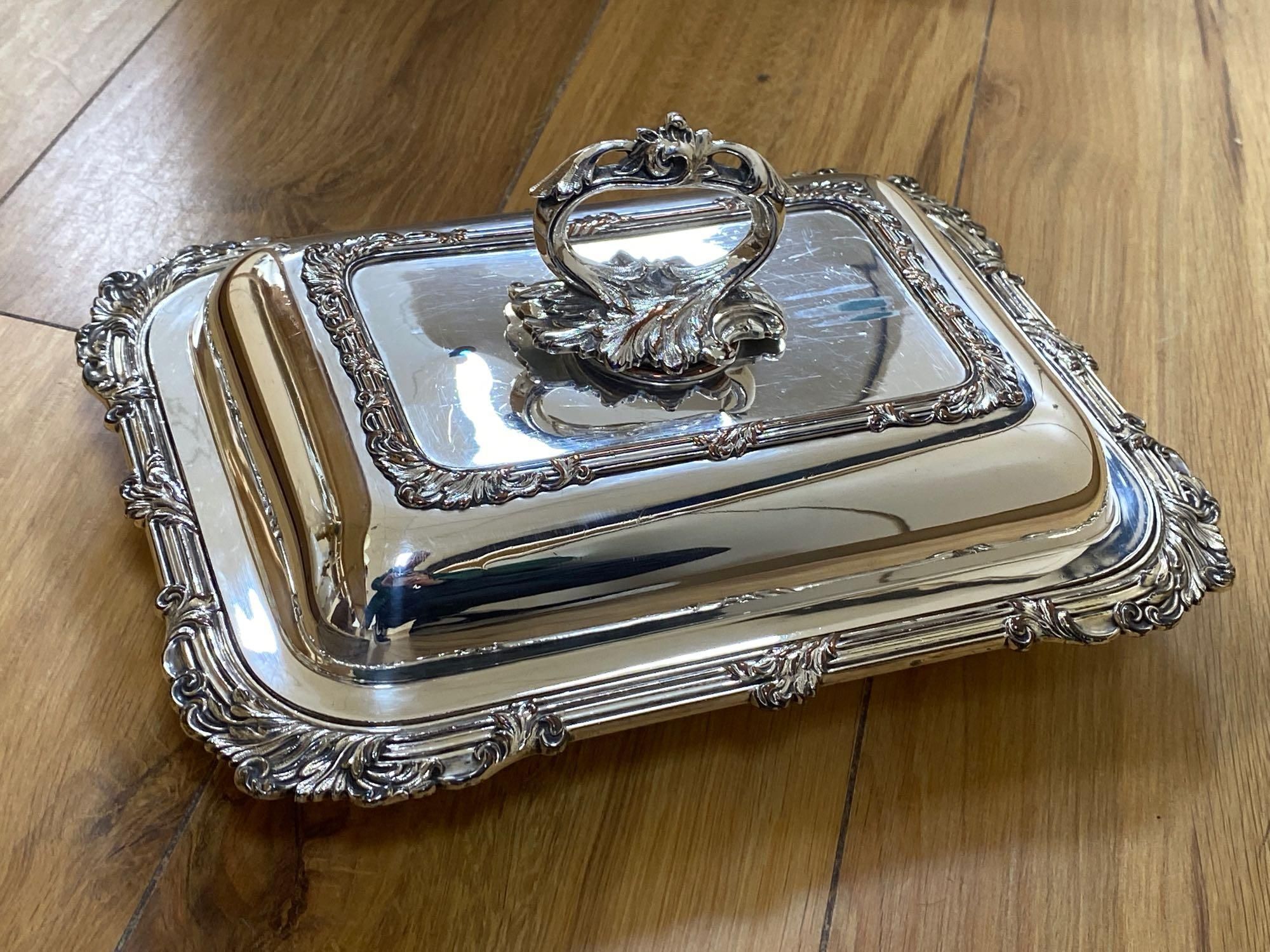 A silver sauce jug, a pair of Victorian plated entree dishes with covers and other plated wares